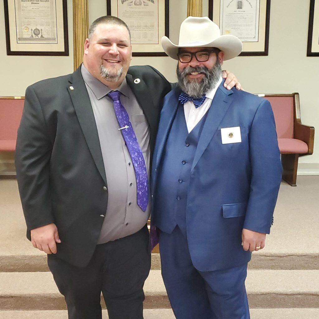 Two Brethren posing beneath the Holiness to the Lord arch at Temple Masonic Lodge